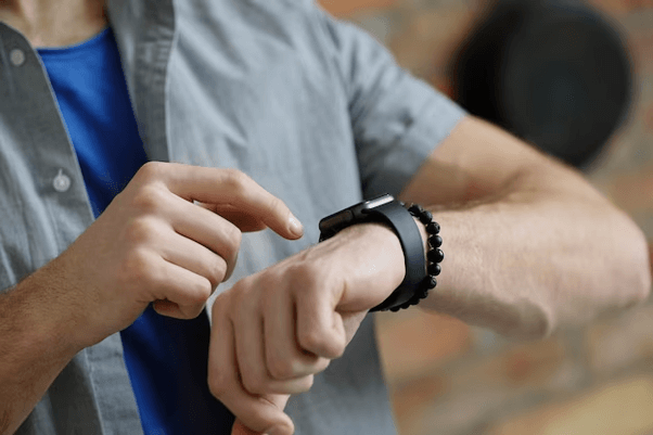 Coach Apple Watch Bands, hands of a man pointing watch on his wrist with forefinger