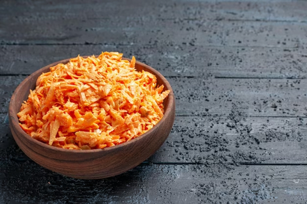 Kazwire: grated carrot salad inside plate on the dark blue rustic desk salad color ripe health diet vegetable