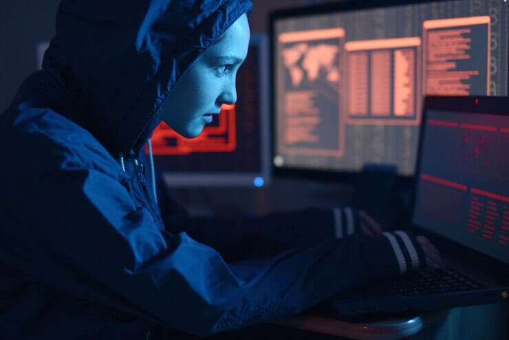 Luscious Net: Female hacker in a hoodie attacking a database