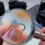 eweler looking at ring with blue stone tourmaline paraiba jewerly inspect and verify pawnshop