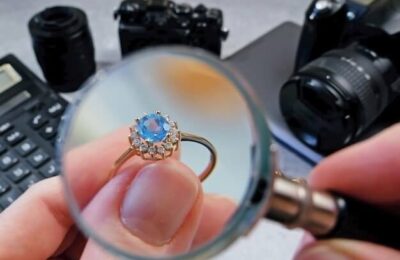 eweler looking at ring with blue stone tourmaline paraiba jewerly inspect and verify pawnshop