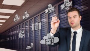 Young businessman writing with marker against digitally generated server room with towers