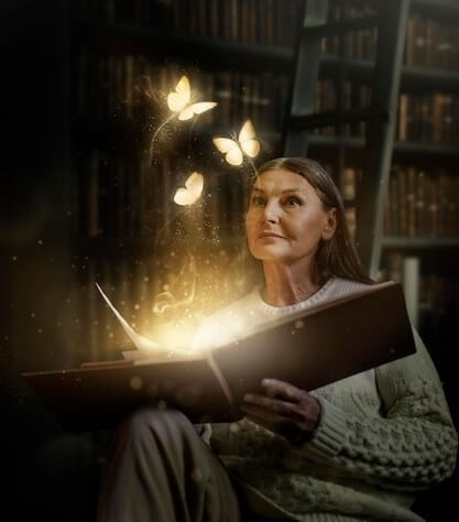 Senior woman holding a book with magical butterflies