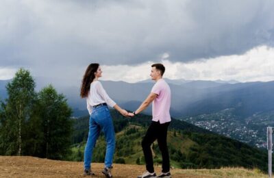 Couple looking to each other at the mountain hills before raining.