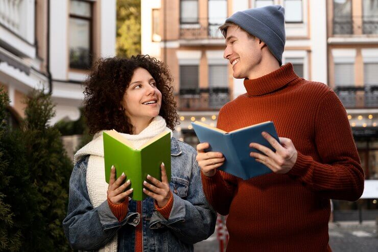 A young boy and girl in happy mood, holding books in hand