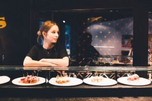 Young hostess near tartines