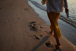 Back view woman walking on the beach