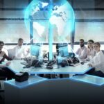 Global network, technology and people concept - business team with computers waving hands at office