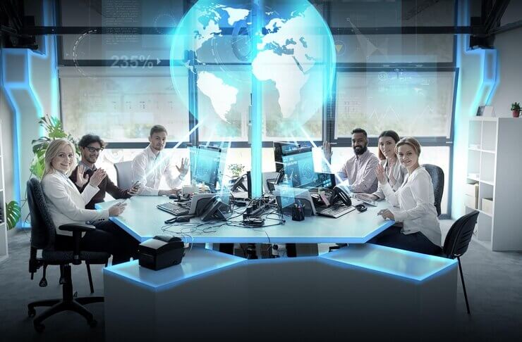 Global network, technology and people concept - business team with computers waving hands at office