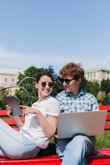 Happy freelancers couple in the park