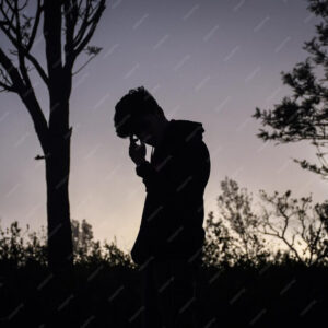 silhouette-man-standing-field-against-sky-sunset
