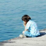 child-by-wooden-dock-beautiful-sea