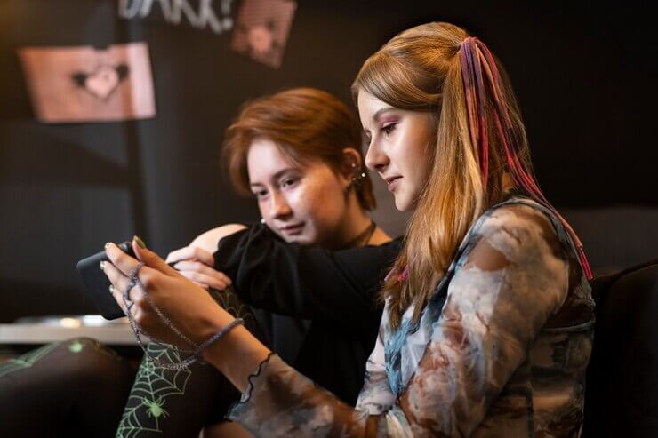 Side view girls looking at smartphone