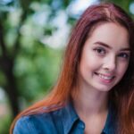 Teenage redhead girl smiling outside