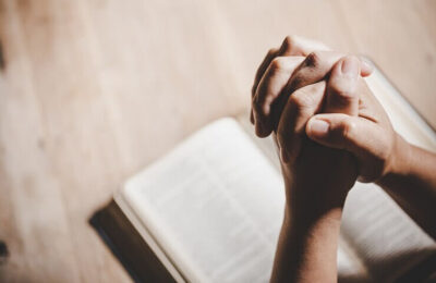 Hands bound on a book for prayer