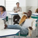 Student Resting his Feet on Top of his Desk