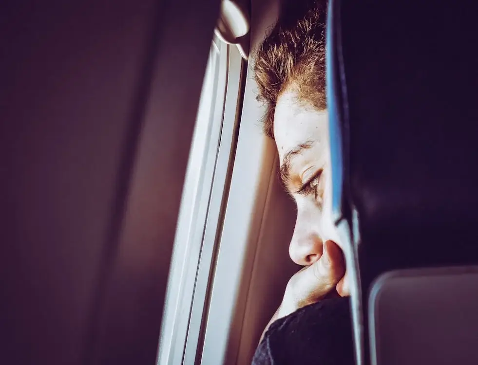 Close-Up Photo of Man Looking Down from the window