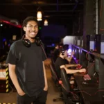 Man in Black Shirt Wearing Black Headphones while Smiling