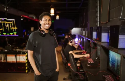 Man in Black Shirt Wearing Black Headphones while Smiling