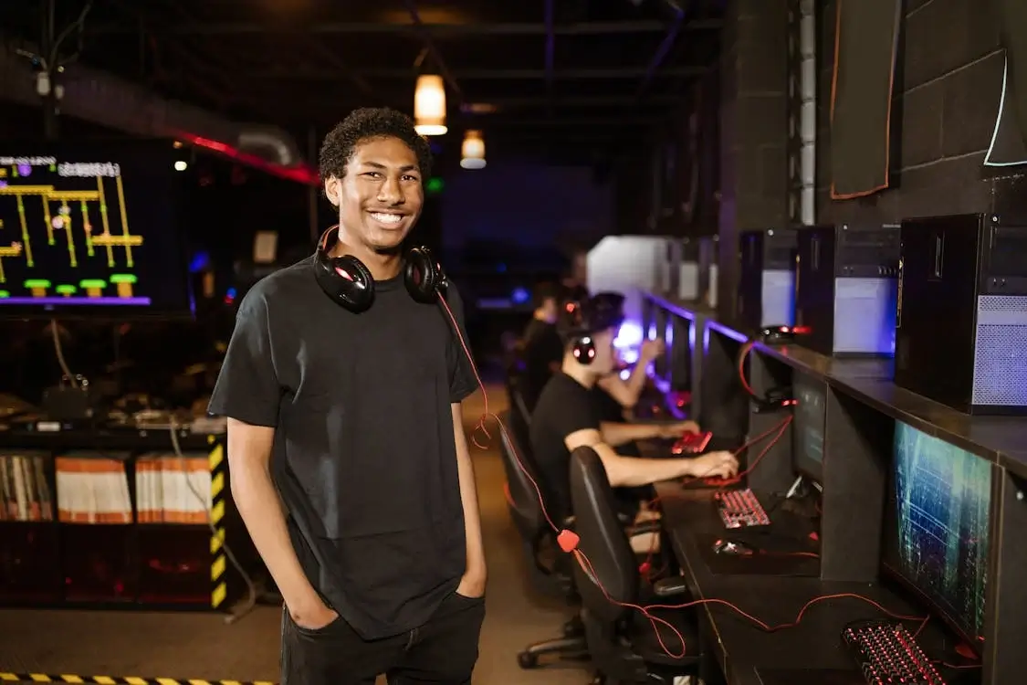 Man in Black Shirt Wearing Black Headphones while Smiling