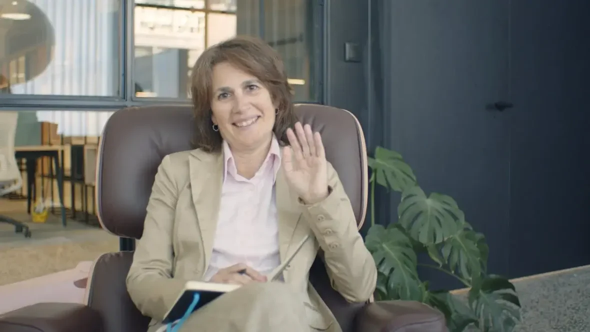 Woman in Beige Blazer Sitting on Brown Leather Chair