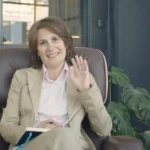 Woman in Beige Blazer Sitting on Brown Leather Chair