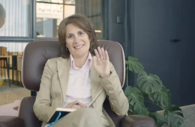 Woman in Beige Blazer Sitting on Brown Leather Chair