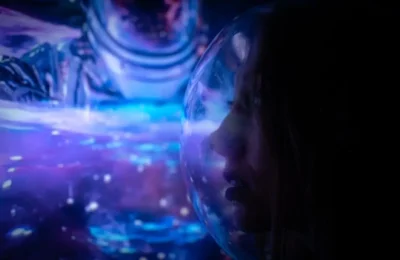 Woman in a Space Helmet Illuminated in Blue