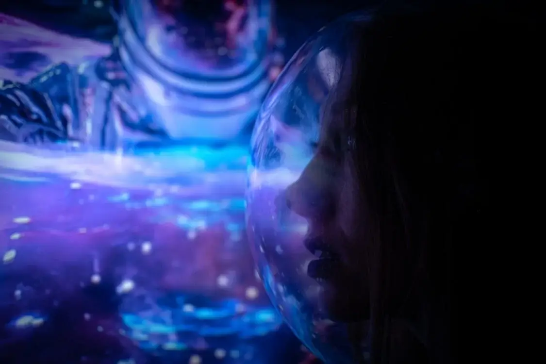 Woman in a Space Helmet Illuminated in Blue