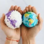 Having world globes in hands