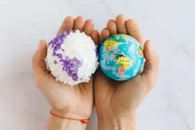 Having world globes in hands