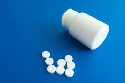 Medicine Tablets Beside a Plastic Container