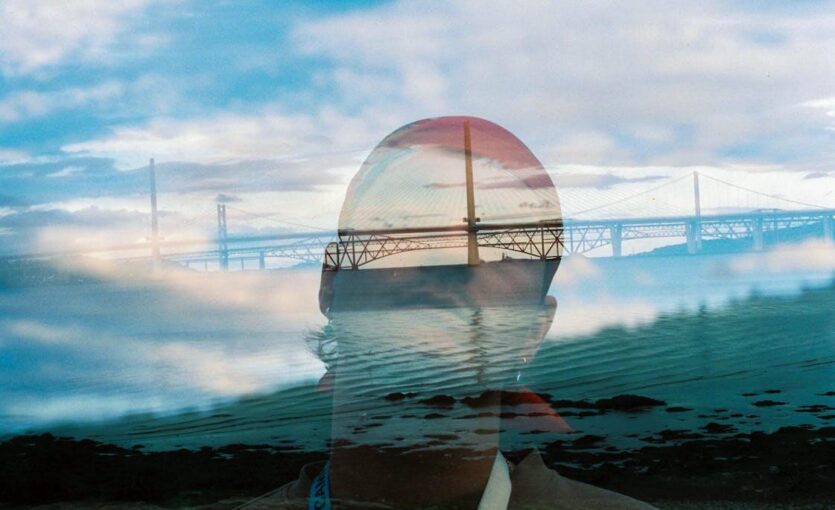 double-exposure-of-man-and-bridge-over-river