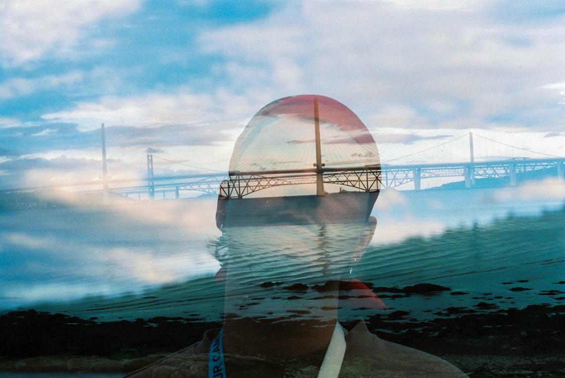 double-exposure-of-man-and-bridge-over-river