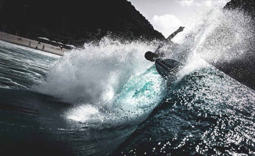 Person Surfing on Sea Waves