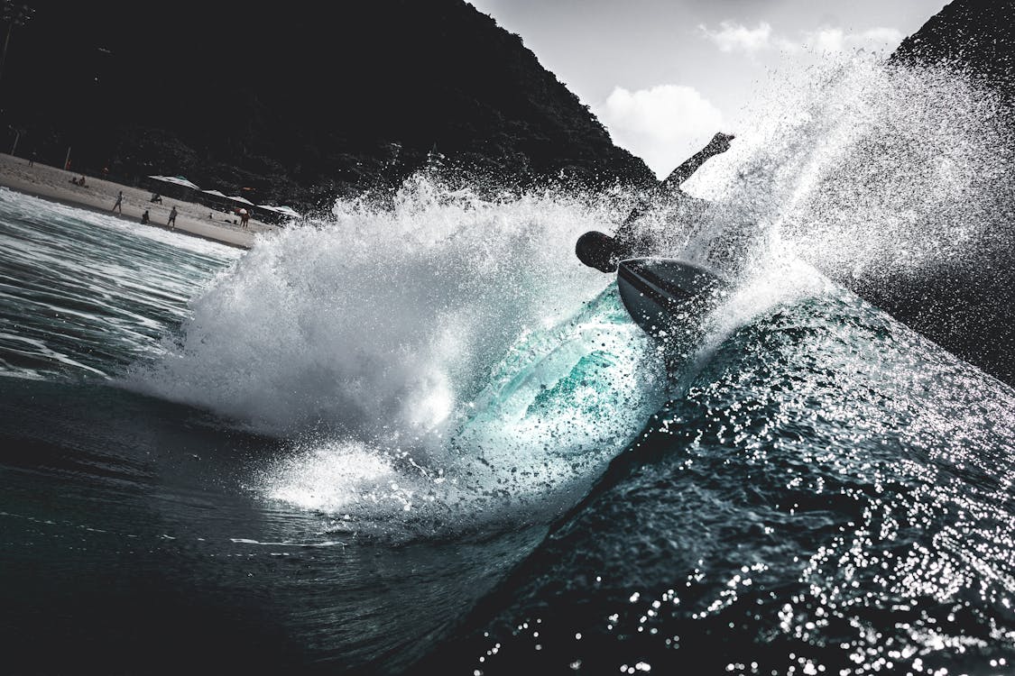 Person Surfing on Sea Waves