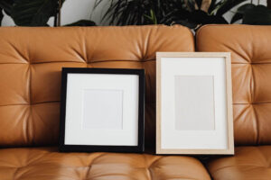 White and Black Picture Frames on Brown Couch