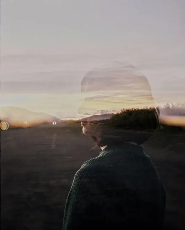 Woman Silhouette behind Window in Village at Sunset