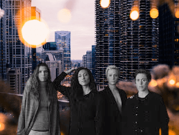 Re Inc Four women pic, in background tall buildings