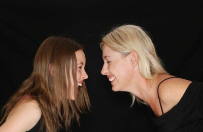 2 Women Smiling face to face