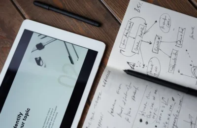 A mobile and writing pad on table