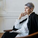Woman in Black Blazer Sitting on Chair