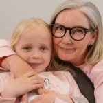 An Elderly Woman Embracing Her Grandchild