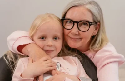 An Elderly Woman Embracing Her Grandchild