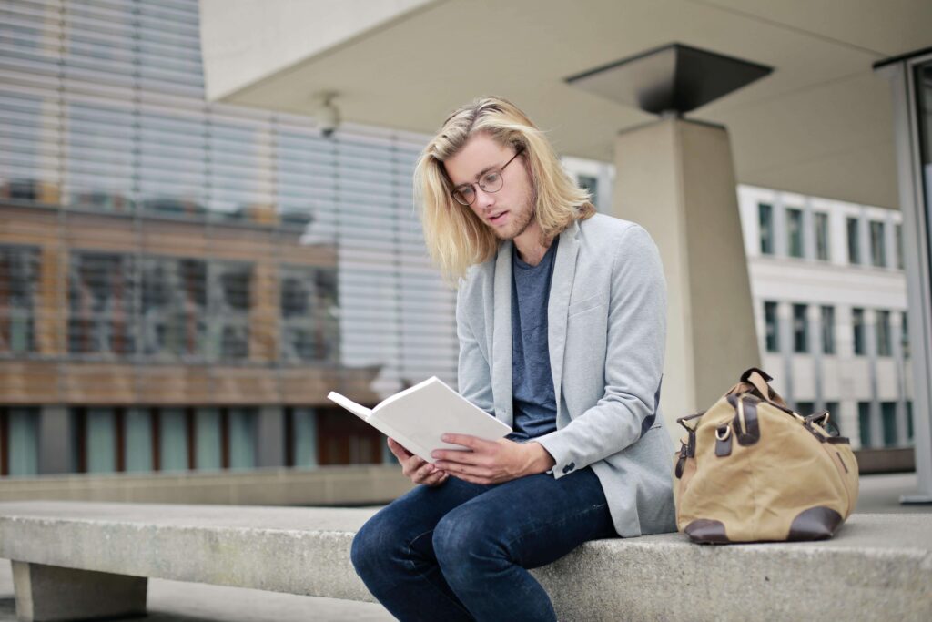 Spiritual Growth Verses, A MAN READING BOOK WHILE SITTING ON TABLE