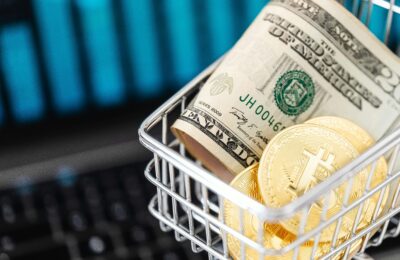 Gold Bitcoin Coins and Cash in a Miniature Shopping Cart