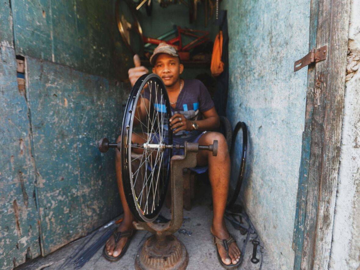 A Man Fixing a Bicycle Rim