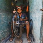 A Man Fixing a Bicycle Rim