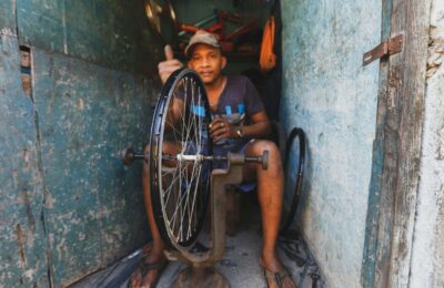 A Man Fixing a Bicycle Rim