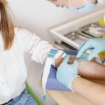 Wellness check, a woman giving blood for test